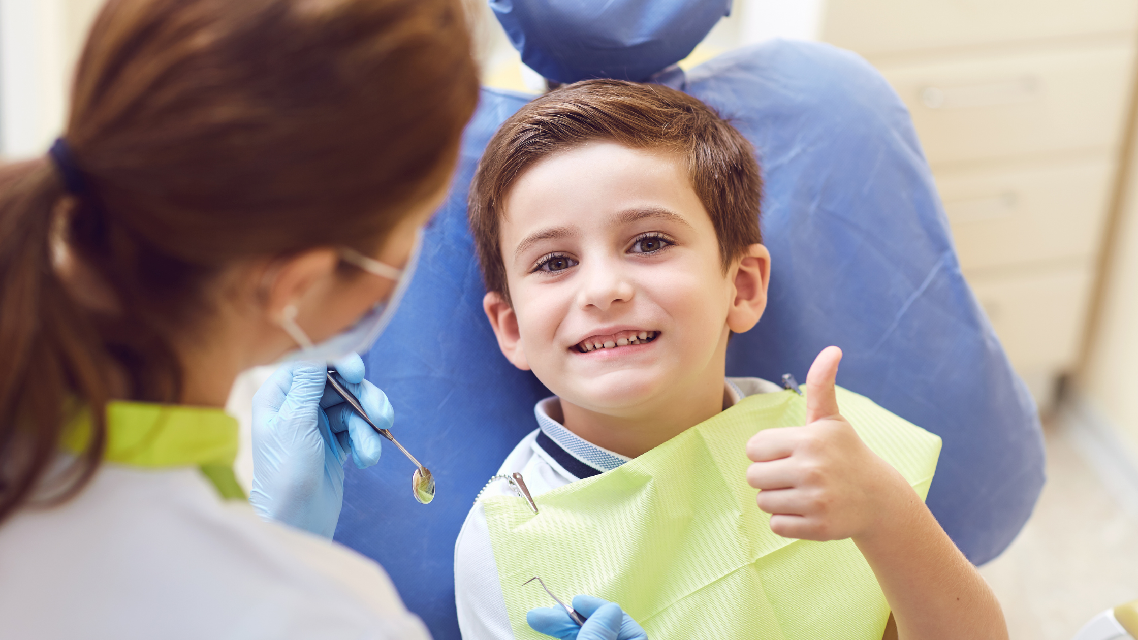 Young patient without dental anxiety, smiling and thumbs up
