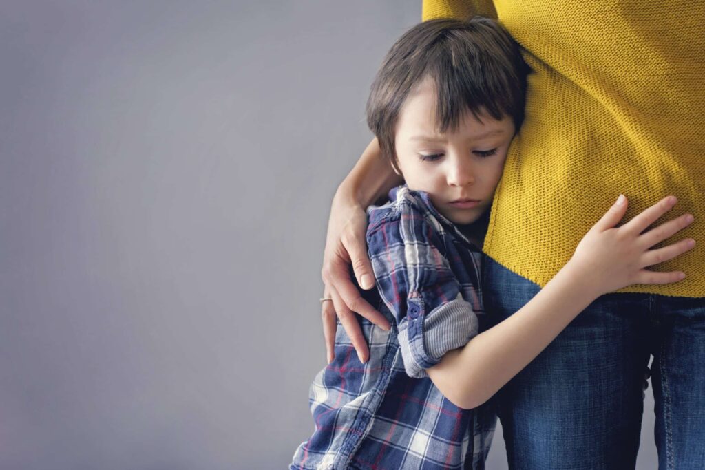 nervous young child hugging a parent before a pediatric dental visit with Little Smiles Pediatric Dentistry in the St. Louis Metro Area