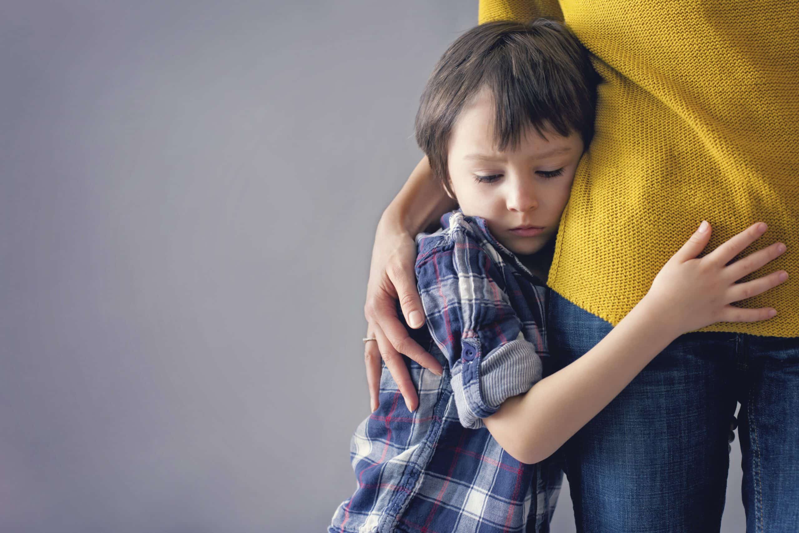nervous young child hugging a parent before a pediatric dental visit with Little Smiles Pediatric Dentistry in the St. Louis Metro Area